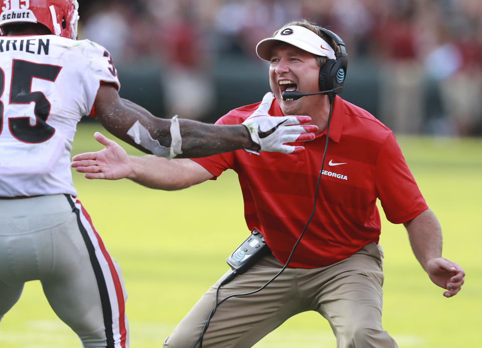 Georgia head coach Kirby Smart celebrates with Brian Herrien (35) after Herrien's touchdown during the second half of an NCAA college football game against South Carolina, Saturday, Sept. 8, 2018, in Columbia, S.C. Georgia won 41-17. (Curtis Compton/Atlanta Journal-Constitution via AP)