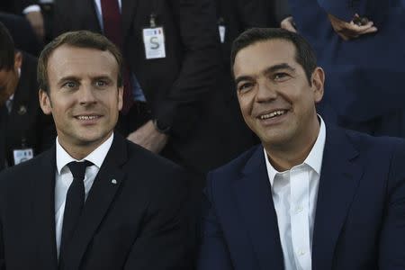 French President Emmanuel Macron and Greek Prime Minister Alexis Tsipras are seen before delivering their speeches atop the Pnyx Hill in Athens, Greece, September 7, 2017. REUTERS/Aris Messinis/Pool