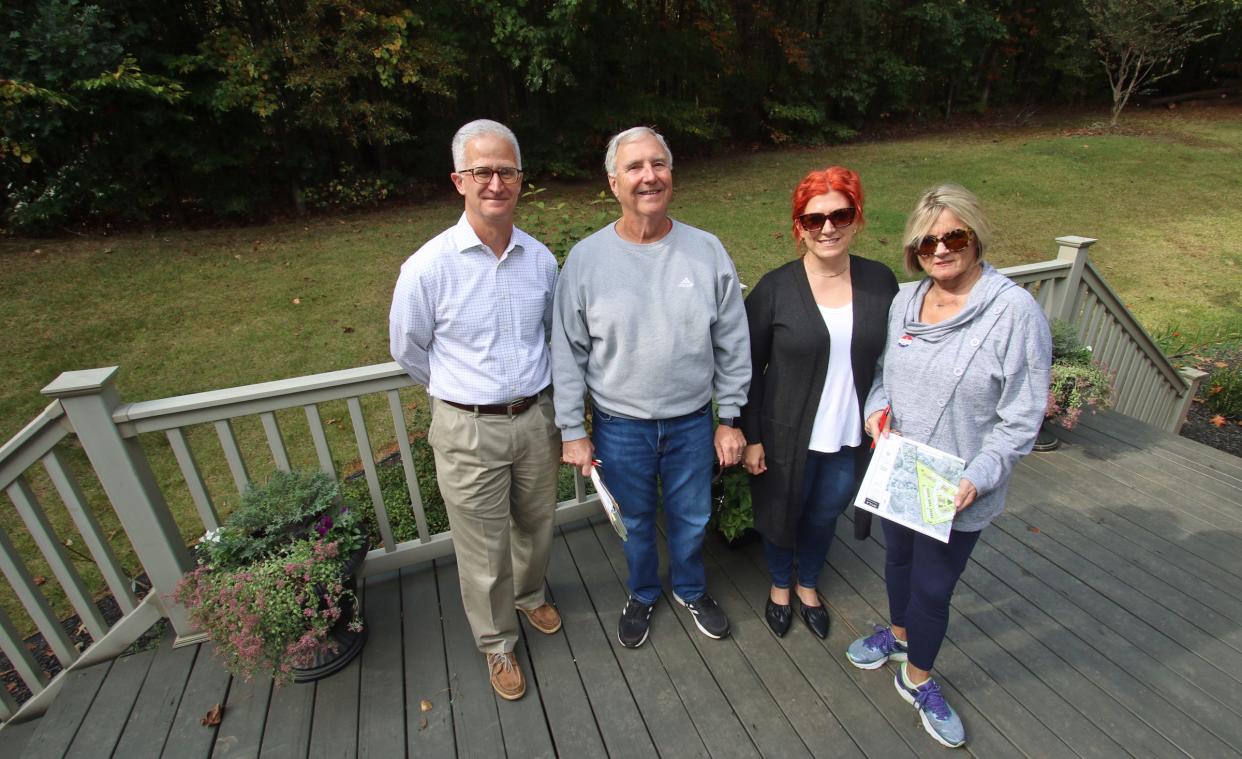 Mark Davis, Bob Ferguson, Kate Hamad and Lisa Dale together on the back deck of Kate Hamad’s home on Candlewick Way near where apartments may be built.