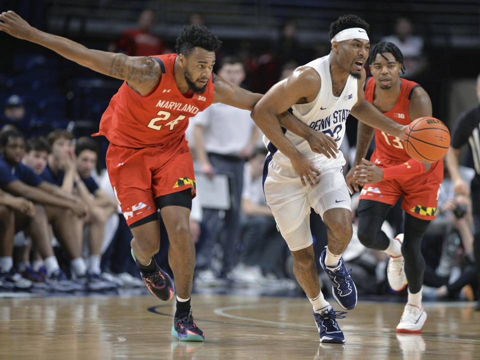 Maryland' sDonta Scott (24) attempts to knock the ball away from Penn State's Jalen Pickett (22) during the first half of an NCAA college basketball game, Sunday, March 5, 2023, in State College, Pa. (AP Photo/Gary M. Baranec)