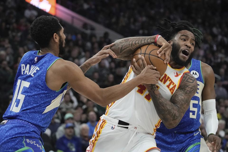 Milwaukee Bucks' Cameron Payne fouls Atlanta Hawks' Saddiq Bey during the first half of an NBA basketball game Saturday, Dec. 2, 2023, in Milwaukee. (AP Photo/Morry Gash)