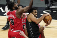 Minnesota Timberwolves center Karl-Anthony Towns, right, rebounds the ball against Chicago Bulls forward Patrick Williams during the second half of an NBA basketball game in Chicago, Wednesday, Feb. 24, 2021. (AP Photo/Nam Y. Huh)
