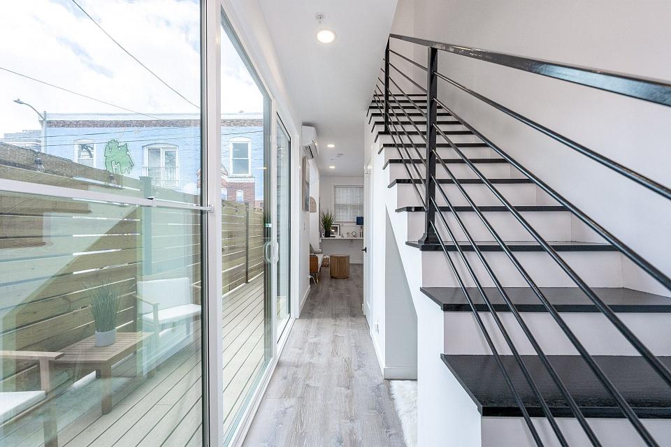 Stairs and floor-to-ceiling windows in a skinny home.