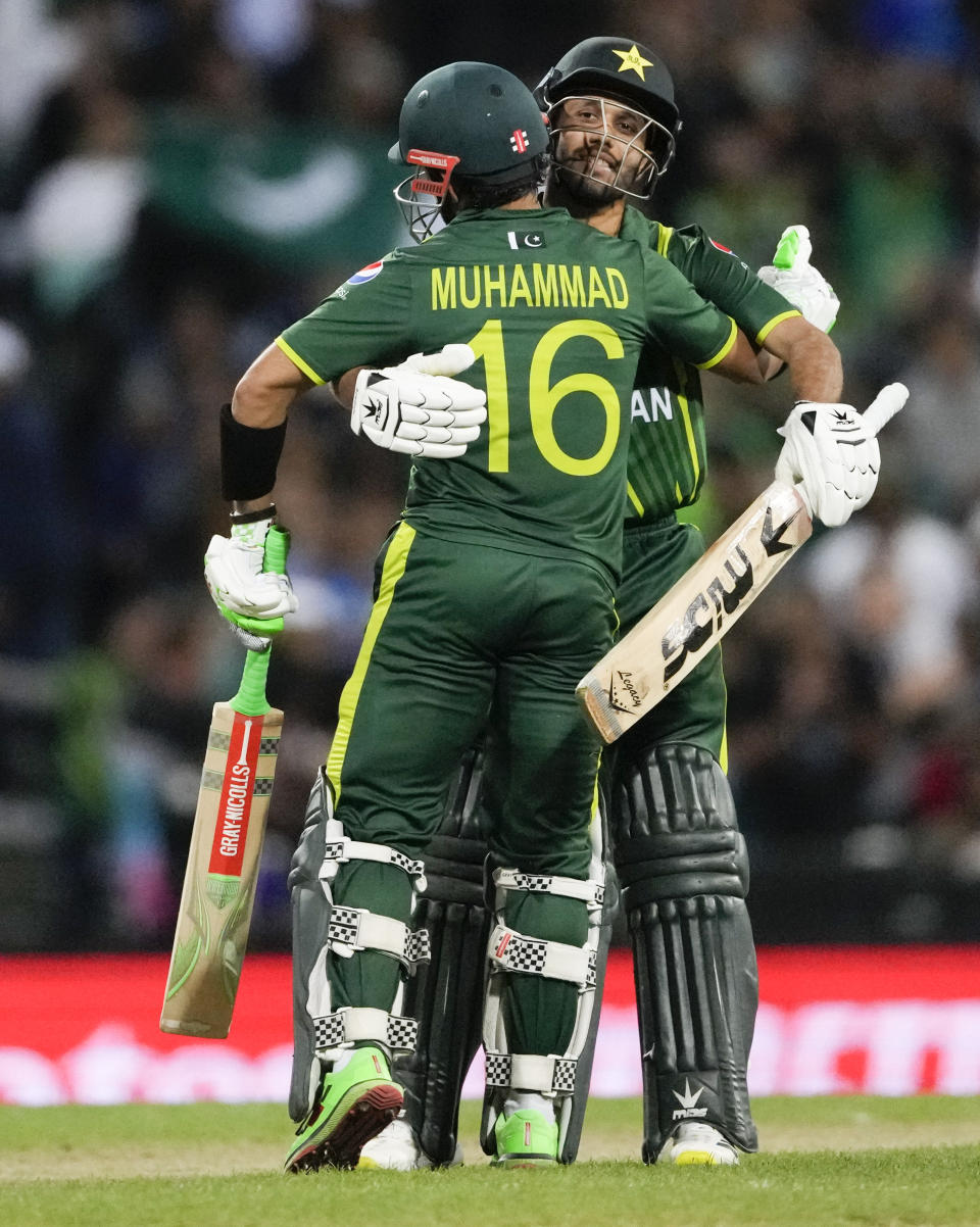 Pakistan's Mohammad Haris, right, congratulates teammate Mohammad Rizwan after he scored 50 runs during the T20 World Cup cricket semifinal between New Zealand and Pakistan in Sydney, Australia, Wednesday, Nov. 9, 2022. (AP Photo/Rick Rycroft)