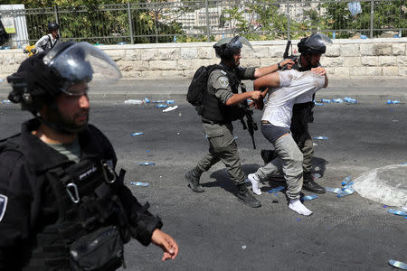 Israeli security forces arrest a Palestinian man following clashes outside Jerusalem's Old city. REUTERS/Ammar Awad