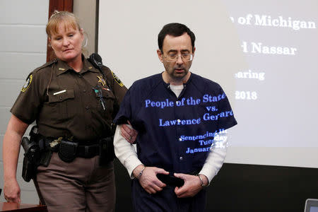 FILE PHOTO: Larry Nassar, a former team USA Gymnastics doctor, who pleaded guilty in November 2017 to sexual assault charges, returns from a break to listen to victim testimony in the courtroom during his sentencing hearing in Lansing, Michigan, U.S., January 23, 2018. REUTERS/Brendan McDermid/File Photo