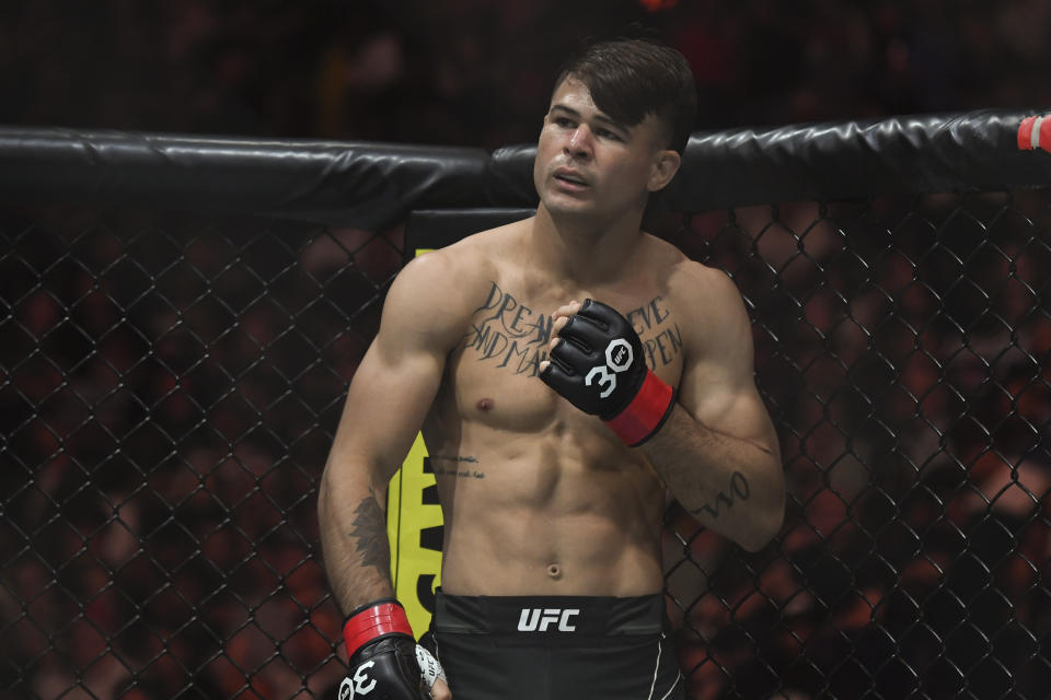 Aug 5, 2023; Nashville, Tennessee, USA; Diego Lopes (red gloves) fights Gavin Tucker (blue gloves) during UFC Fight Night at Bridgestone Arena. Mandatory Credit: Christopher Hanewinckel-USA TODAY Sports