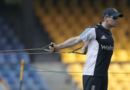 England's Eoin Morgan stretches during a practice session ahead of their fourth ODI (One Day International) cricket match against Sri Lanka, in Colombo December 6, 2014. REUTERS/Dinuka Liyanawatte