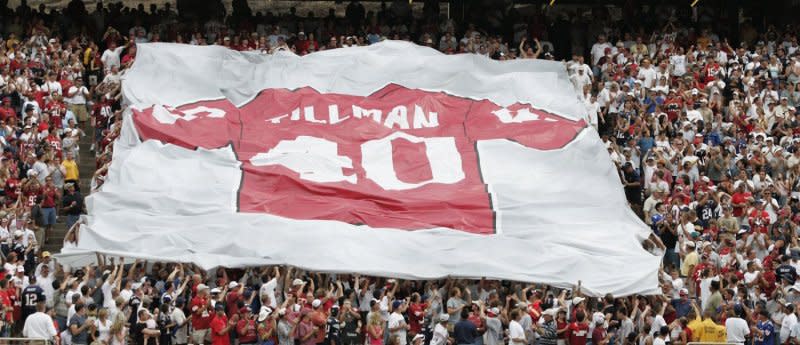 During halftime between the New England Patriots and the Arizona Cardinals, a large banner is displayed with the number of Cpl. Pat Tillman on September 19, 2004, in Tempe, Ariz. On April 22, 2004, Tillman, who turned down a lucrative contract with the Arizona Cardinals to join the U.S. Army Rangers, was killed in Afghanistan. File Photo by Will Powers/UPI