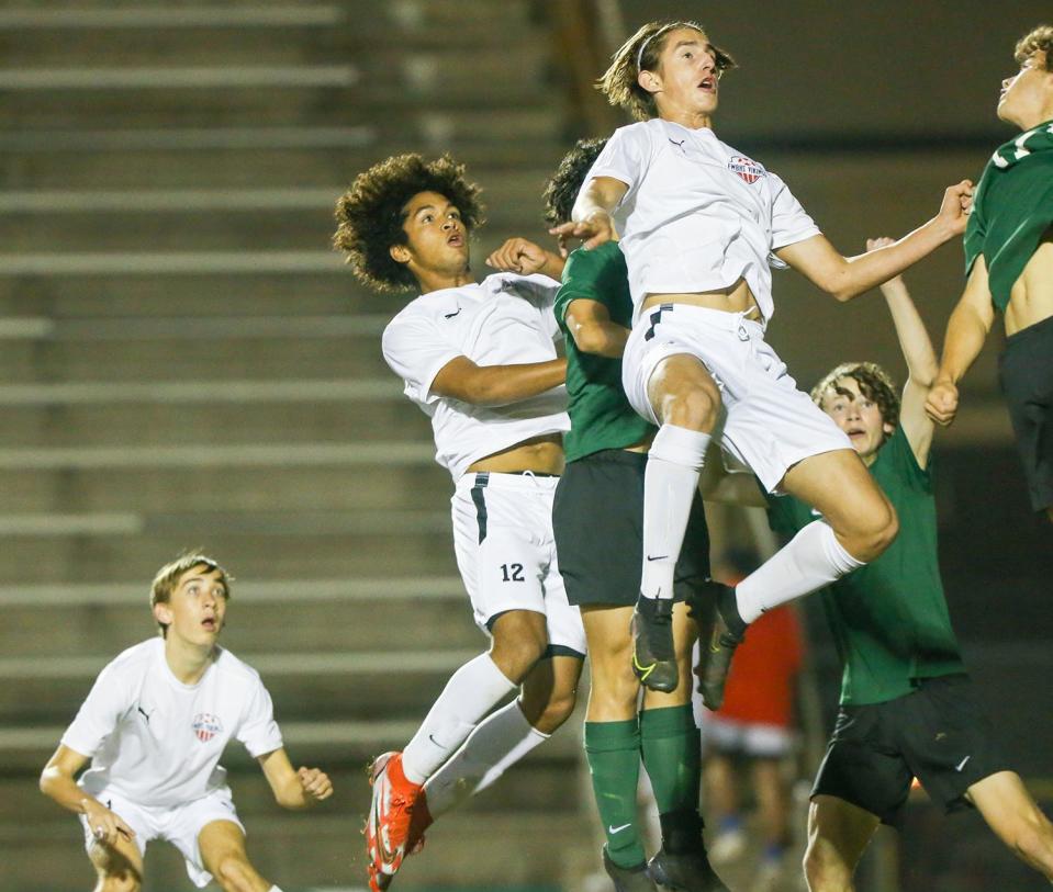 Elijah Oswald and Quinn Carper leap for the ball in the Fort Walton Beach Choctaw boys soccer match at Choctaw.