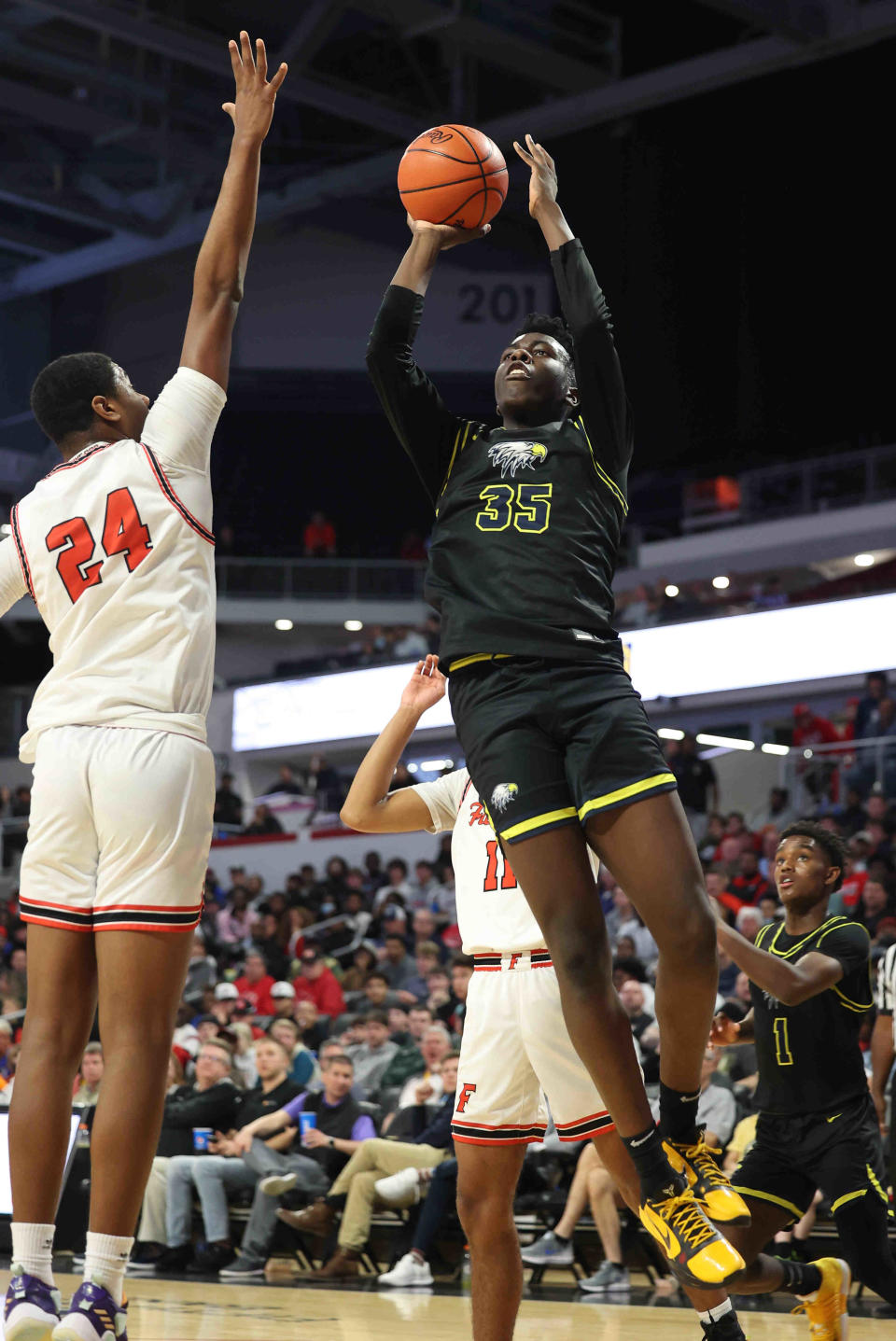 Walnut Hills center Tyler McKinley shoots the ball over Fairfield center Aamir Rogers (24) during their district final, Sunday, March 6, 2022. McKinley transferred to Link Academy in Missouri for last season. He commited to Wes Miller's Cincinnati Bearcats June 8.