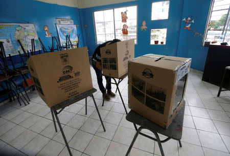 A man casts his vote in a school used as a polling station during the presidential election, in Guayaquil, Ecuador April 2, 2017. REUTERS/Henry Romero