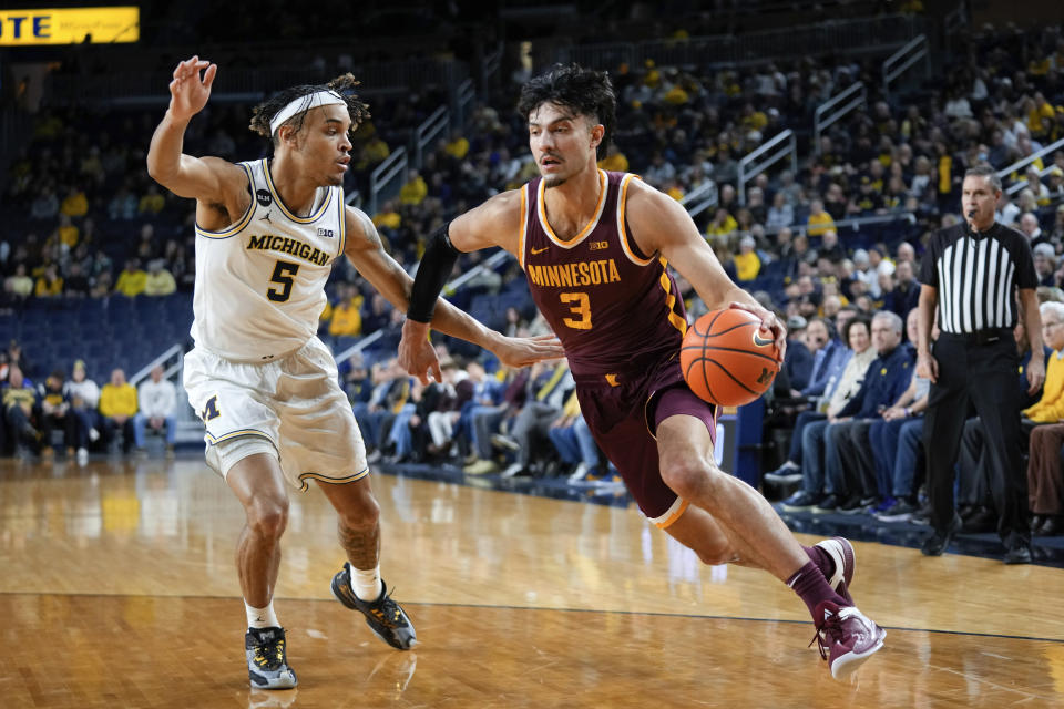 Minnesota forward Dawson Garcia (3) drives on Michigan forward Terrance Williams II (5) in the first half of an NCAA college basketball game in Ann Arbor, Mich., Sunday, Jan. 22, 2023. (AP Photo/Paul Sancya)