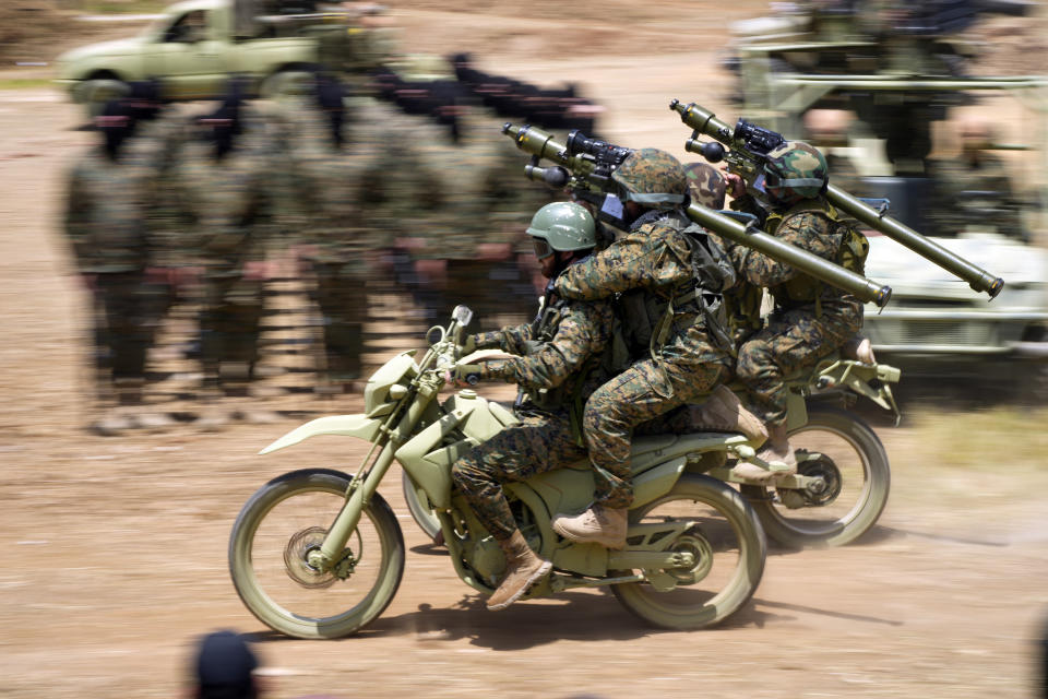 Fighters from the Lebanese militant group Hezbollah ride their motorcycles during a training exercise in Aaramta village in the Jezzine District, southern Lebanon, Sunday, May 21, 2023. The show of force came ahead of "Liberation Day," the annual celebration of the withdrawal of Israeli forces from south Lebanon on May 25, 2000, and in the wake of a recent escalation of the Israel-Palestine conflict in the Gaza Strip. (AP Photo/Hassan Ammar)