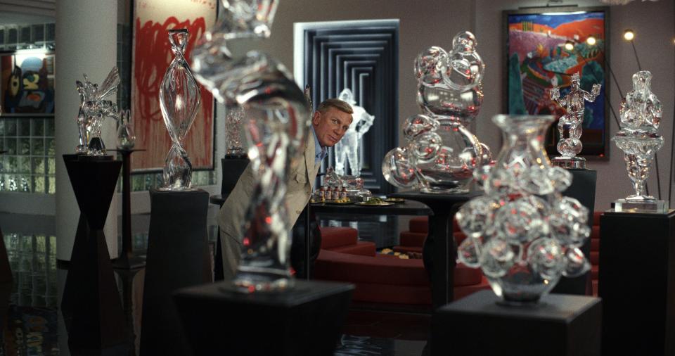 Daniel Craig surrounded by glass sculptures