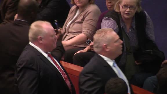 Toronto Mayor Rob Ford and his brother, councillor Doug Ford, argue with members of the public in council chambers Monday.