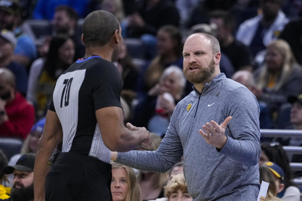 Memphis Grizzlies head coach Taylor Jenkins questions referee Phenizee Ransom (70) during the first half of an NBA basketball game against the Indiana Pacers in Indianapolis, Sunday, Jan. 28, 2024. (AP Photo/Michael Conroy)