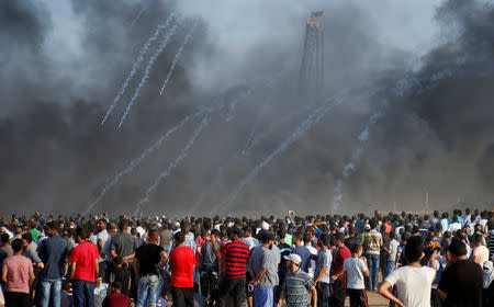 Tear gas canisters are fired by Israeli troops at Palestinians during a protest calling for lifting the Israeli blockade on Gaza and demanding the right to return to their homeland, at the Israel-Gaza border fence east of Gaza City September 28, 2018. REUTERS/Mohammed Salem