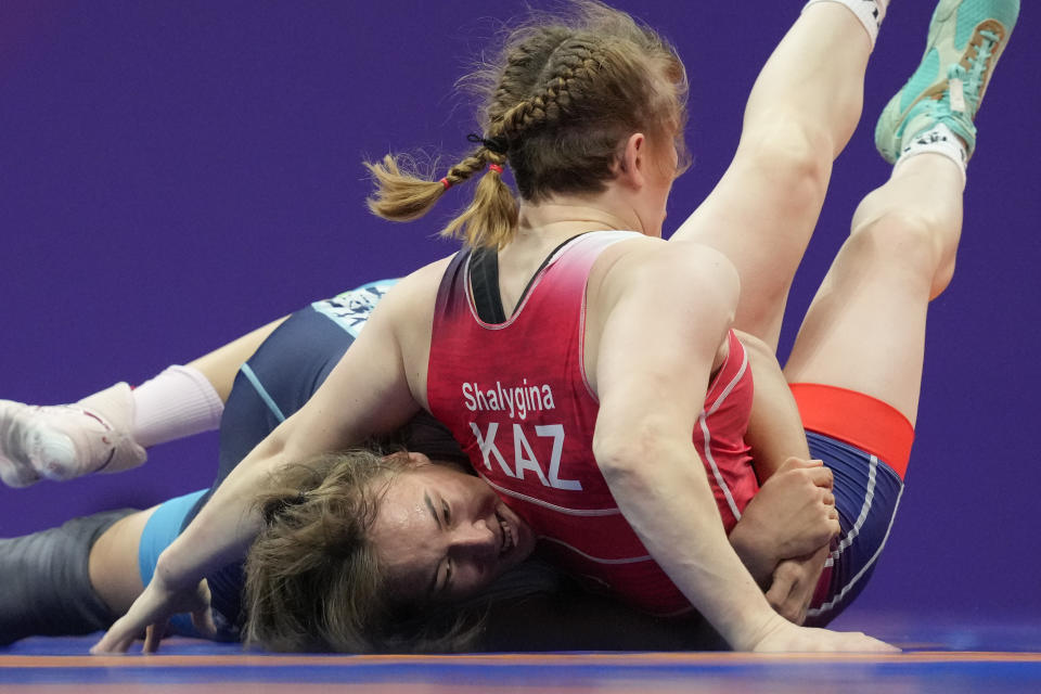 Kyrgyzstan's Nurzat Urtaeva, left, and Kazakhstan's Yelena Shalygina compete during their Women's Freestyle 68Kg wrestling quarterfinal at the 19th Asian Games in Hangzhou, China, Friday, Oct. 6, 2023. (AP Photo/Aaron Favila)