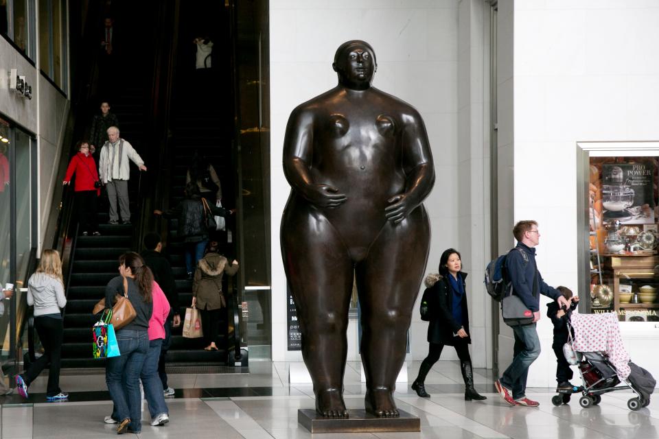 Visitors to the Time Warner Center walk around the Fernando Botero sculpture titled Eve in New York,  Oct. 30, 2013.