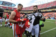 FILE - Kansas City Chiefs tight end Travis Kelce, left, and his brother, Philadelphia Eagles center Jason Kelce (62) prepare to exchange jerseys following an NFL football game in Kansas City, Mo., on Sept. 17, 2017. For the first time in Super Bowl history, a pair of siblings will square off on the NFL’s grandest stage. (AP Photo/Ed Zurga, File)