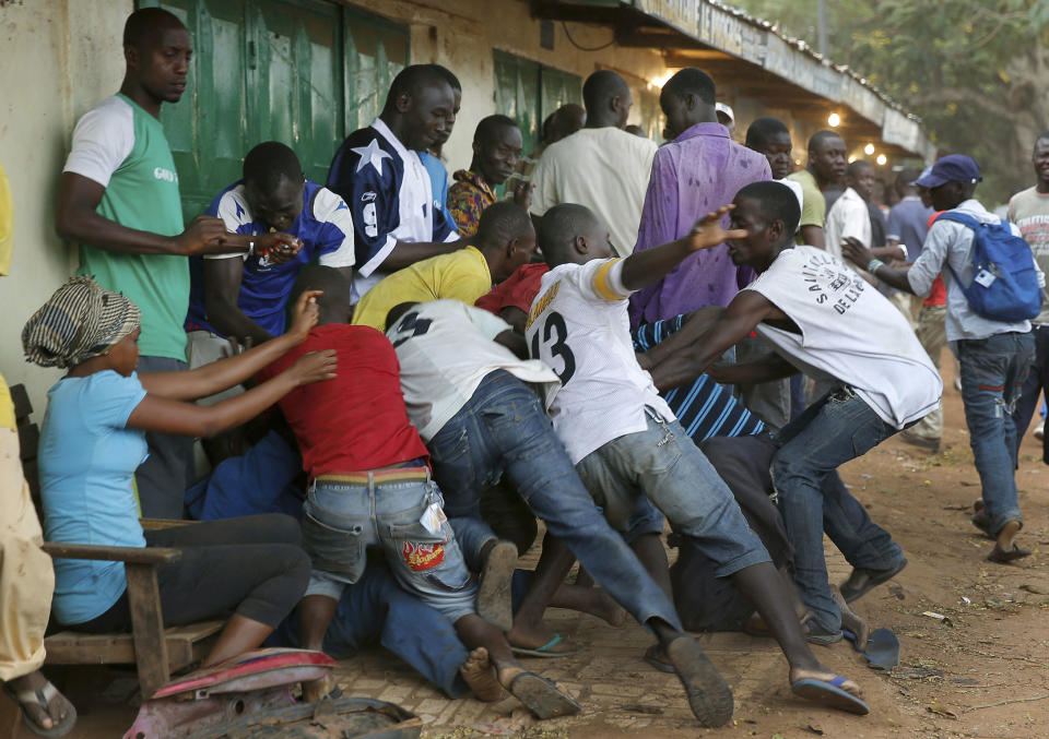 FILE - In this Dec. 9, 2013, file photo, mobs of Christians attack suspected Seleka members near the airport in Bangui, Central African Republic. Some 20 percent of schools in Central African Republic are not functioning, and students’ and teachers’ lives are threatened as armed groups have looted, occupied and damaged the properties in the conflict-torn country, according to a Human Rights Watch report released Thursday, March 23, 2017. An education is a rare opportunity for children in the impoverished country to get ahead. (AP Photo/Jerome Delay, File)