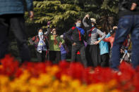 Women, some wearing face masks to help curb the spread of the coronavirus, practice social dance at a park in Beijing, Thursday, Nov. 5, 2020. China is suspending entry for most foreign passport holders who reside in Britain, reacting to a new surge of coronavirus cases in the United Kingdom. (AP Photo/Andy Wong)