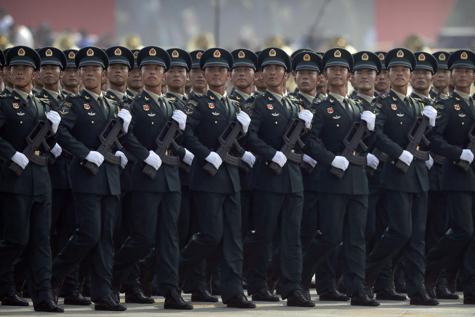 Members of China's People's Liberation Army (PLA) Rocket Force march in formation during a parade to commemorate the 70th anniversary of the founding of Communist China in Beijing, Tuesday, Oct. 1, 2019. Trucks carrying weapons including a nuclear-armed missile designed to evade U.S. defenses rumbled through Beijing as the Communist Party celebrated its 70th anniversary in power with a parade Tuesday that showcased China's ambition as a rising global force. (AP Photo/Mark Schiefelbein)