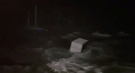 A cargo container floats at sea during storm in Hamilton