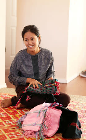 Htoo Lwae Say shows some of the items she brought with her to the United States in her home in Garden City, Kansas, U.S., March 27, 2018. REUTERS/Adam Shrimplin