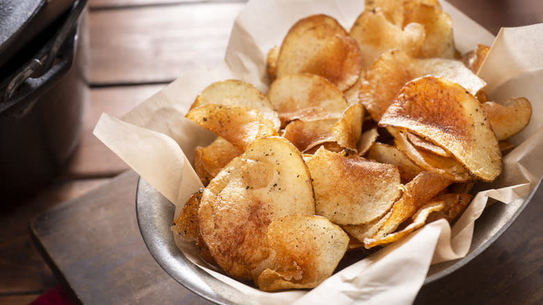 Bowl of potato chips with parchment