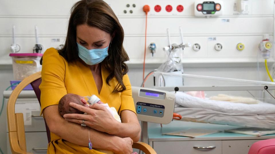 Kate Middleton holding a small baby