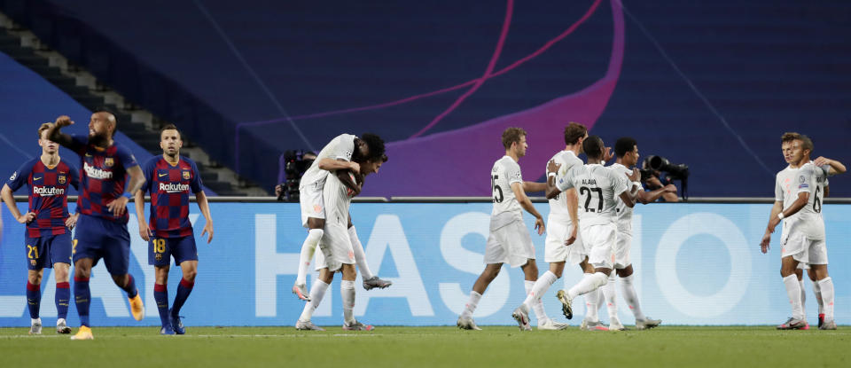 Bayern's Thomas Mueller celebrates with teammates after scoring his sides fourth goal during the Champions League quarterfinal match between FC Barcelona and Bayern Munich at the Luz stadium in Lisbon, Portugal, Friday, Aug. 14, 2020. (AP Photo/Manu Fernandez/Pool)