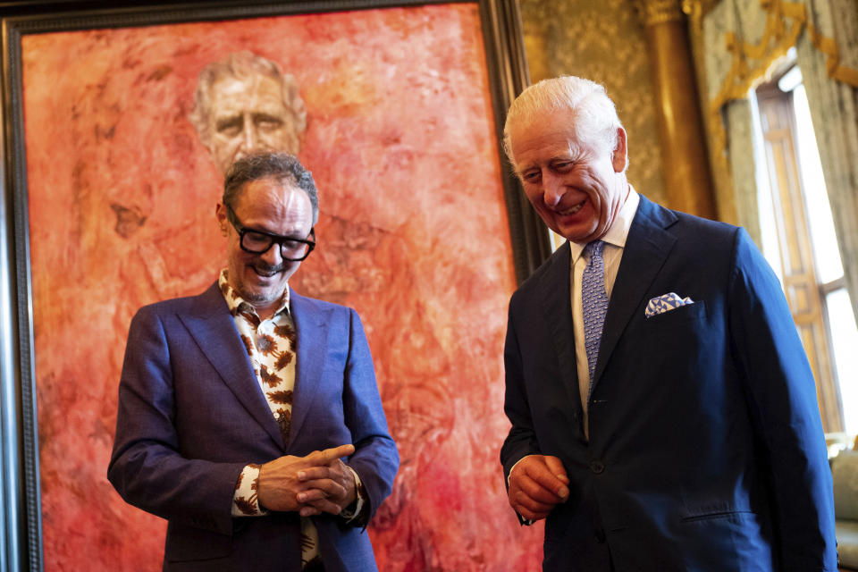 Artist Jonathan Yeo, left, and Britain's King Charles III at the unveiling of Yeo's portrait of the King, in the blue drawing room at Buckingham Palace, in London, Tuesday May 14, 2024. The portrait was commissioned in 2020 to celebrate the then Prince of Wales's 50 years as a member of The Drapers' Company in 2022. The artwork depicts the King wearing the uniform of the Welsh Guards, of which he was made Regimental Colonel in 1975. The canvas size - approximately 8.5 by 6.5 feet when framed - was carefully considered to fit within the architecture of Drapers' Hall and the context of the paintings it will eventually hang alongside. (Aaron Chown/Pool Photo via AP)