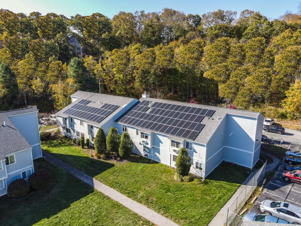 Journal file photo showing an apartment building in West Warwick with rooftop solar panels.