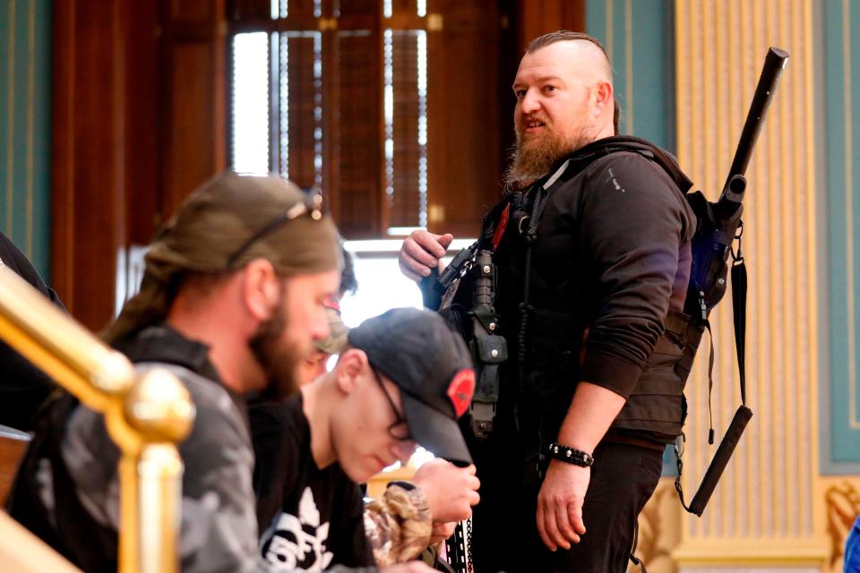 William Null, right, stands in the gallery of the Michigan Senate Chamber at the state Capitol in Lansing during a rally April 30, 2020, organized by Michigan United for Liberty. The group was demanding the reopening of businesses amid the coronavirus pandemic.