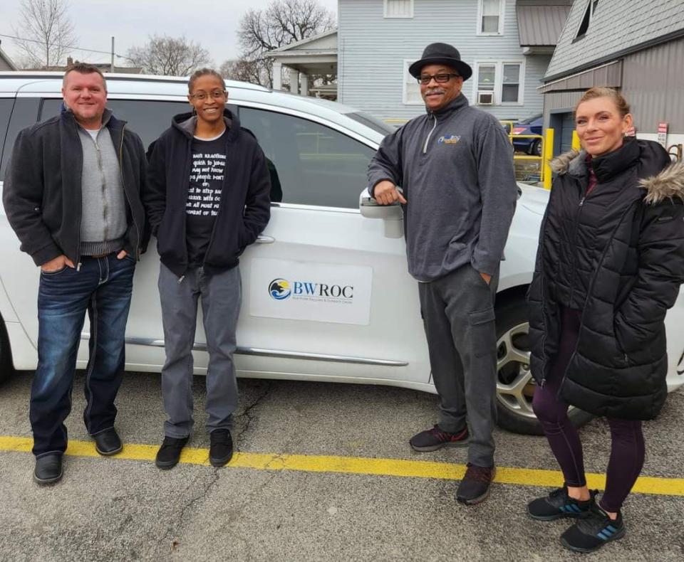 Organizers stand next to Blue Water Recovery and Outreach Center's van, which was purchased last year with the help of American Rescue Plan Act dollars through the city of Port Huron.  Early this month, the vehicle was in the shop for repairs.