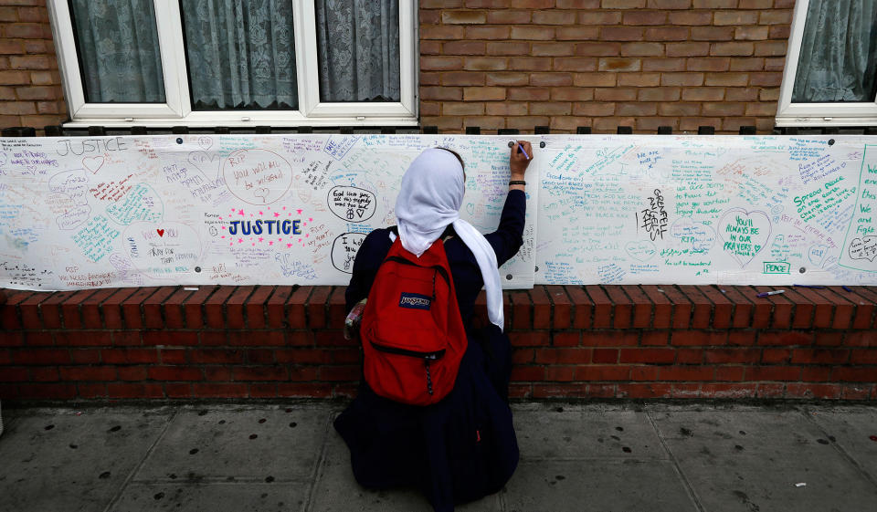 <p>A woman signs a message board near Grenfell Tower in London, Saturday, June 17, 2017. Police Commander Stuart Cundy said Saturday it will take weeks or longer to recover and identify all the dead in the public housing block that was devastated by a fire early Wednesday. (AP Photo/Kirsty Wigglesworth) </p>