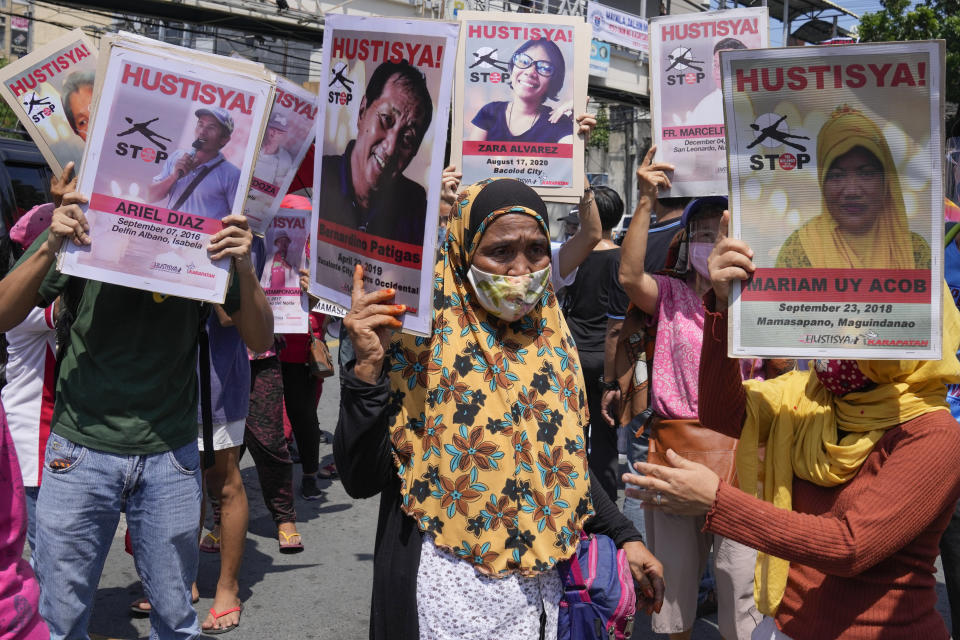 Protesters hold pictures of alleged victims of extra-judicial killings during a rally outside the Malacanang palace in Manila, Philippines on Wednesday, June 30, 2021. The group has called for justice and accountability for the thousands who have died due to the government's anti-drug crackdown under the administration of Philippine President Rodrigo Duterte. (AP Photo/Aaron Favila)