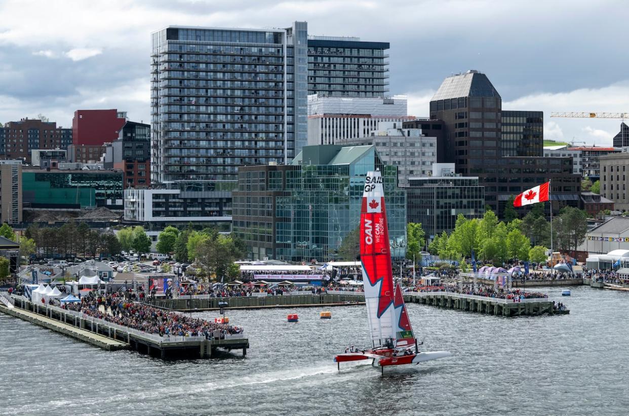 Canada's SailGP team passes by onlookers lining Halifax harbour. The event attracted some 50,000 people during the first weekend of June.  (Ricardo Pinto/SailGP via AP - image credit)