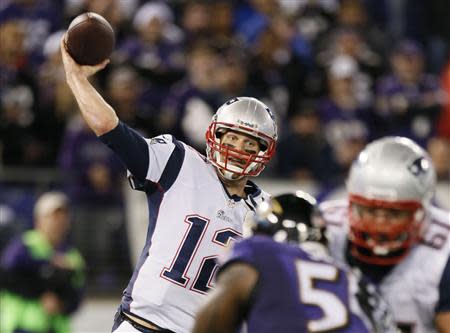 Dec 22, 2013; Baltimore, MD, USA; New England Patriots quarterback Tom Brady (12) passes against the Baltimore Ravens at M&T Bank Stadium. Mandatory Credit: Mitch Stringer-USA TODAY Sports