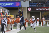 West Virginia wide receiver Kaden Prather (3) reaches for a pass as Texas defensive back B.J. Foster (25) moves in during the first half of an NCAA college football game in Morgantown, W.Va., Saturday, Nov. 20, 2021. (AP Photo/Kathleen Batten)