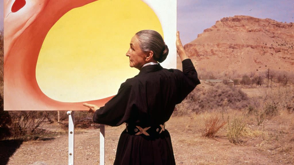 georgia o'keeffe with painting in desert, nm