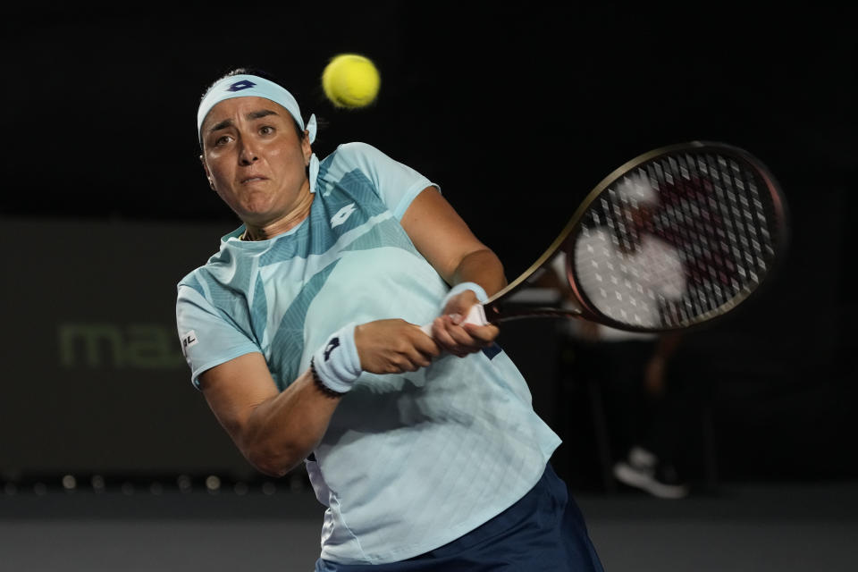 FILE - Ons Jabeur, of Tunisia, returns a shot to Iga Swiatek, of Poland, during a women's singles match at the WTA Finals tennis championships in Cancun, Mexico, Friday, Nov. 3, 2023. Jabeur is one of the players to watch at the Australian Open. The year's first Grand Slam tennis tournament is scheduled to start at Melbourne Park on Sunday, Jan. 14. (AP Photo/Fernando Llano, File)