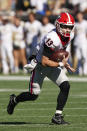 Georgia quarterback Stetson Bennett (13) scrambles in the first half of an NCAA college football game against Georgia Tech Saturday, Nov. 27, 2021, in Atlanta. (AP Photo/John Bazemore)