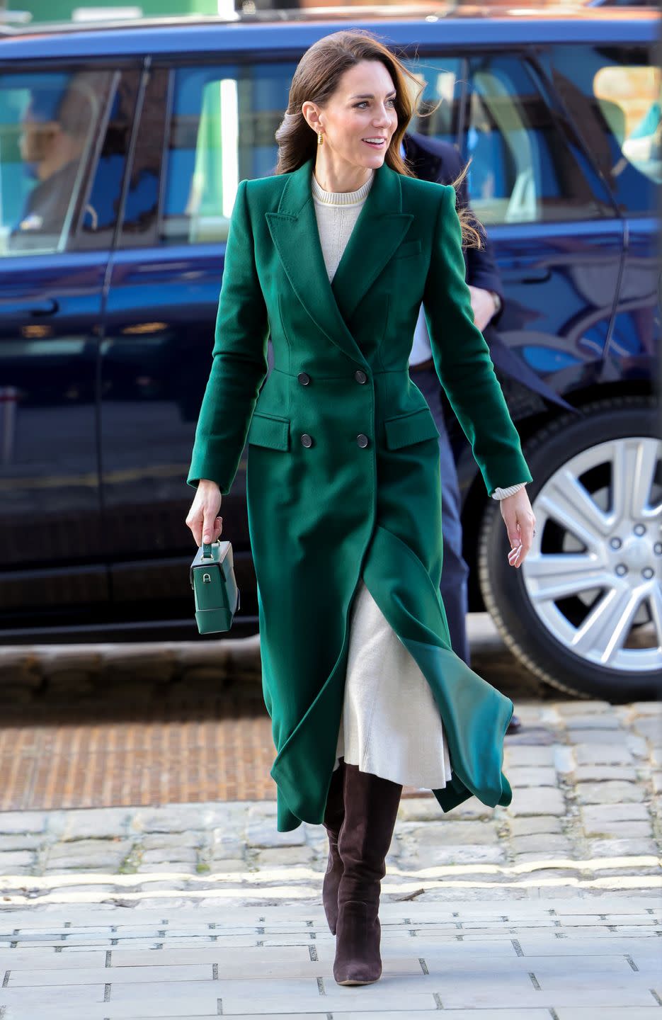 <p>Kate dressed for the cold weather, wearing a new bespoke emerald green coat by Alexander McQueen and brown Gianvito Rossi boots.</p>