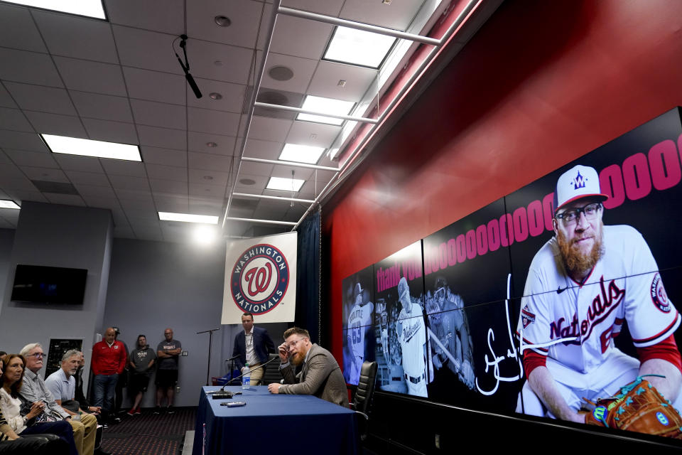 Washington Nationals relief pitcher Sean Doolittle, right, speaks at a news conference after announcing his retirement at Nationals Park, Friday, Sept. 22, 2023, in Washington. Doolittle has decided to retire from baseball after more than a decade pitching in the majors that included helping the Nationals win the World Series in 2019. (AP Photo/Andrew Harnik)