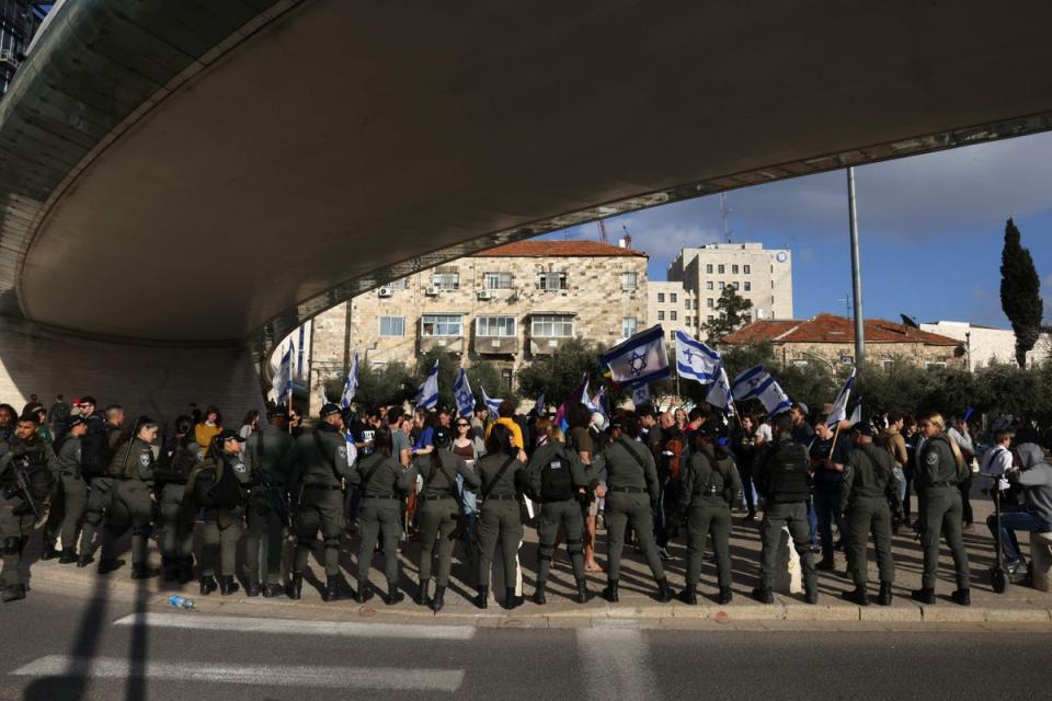 Israeli police stand guard as protesters gather outside Israel’s parliament (AFP via Getty)