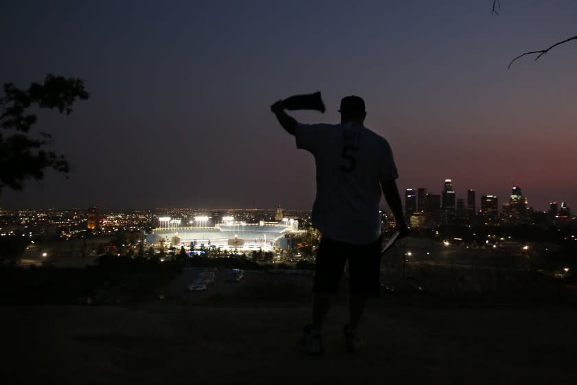 LOS ANGELES, CA - SEPTEMBER 30: Josh Gitt waves a bandana as the Dodgers in Game 1.