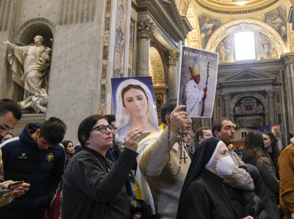 People queue to see off late Pope Emeritus Benedict XVI lying out in state inside St. Peter's Basilica at The Vatican where thousands went to pay their homage Tuesday, Jan 3, 2023. Pope Benedict, the German theologian who will be remembered as the first pope in 600 years to resign, has died, the Vatican announced Saturday, Dec. 31, 2022. He was 95. (AP Photo/Antonio Calanni)